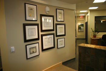 Wall with Dr. Verschueren's degrees and certificates